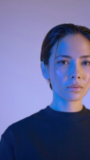 Stunning Close-Up Portrait of a Woman with Blue Neon Lighting Wallpaper