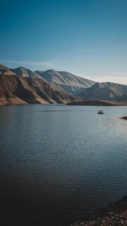 Scenic Boat Trip on Serene Mountain Lake Mobile Wallpaper