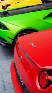 Stunning Trio of Exotic Supercars in Red Green and Yellow Mobile Wallpaper