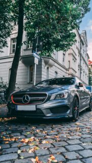 Mercedes-Benz CLA AMG Grey Car on Cobblestone Street Wallpaper