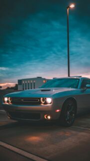 Silver Dodge Challenger at Dusk Street Lighting Mobile Wallpaper