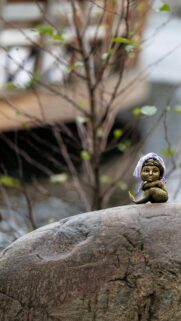 Tiny Mermaid Bronze Statue on a River Rock Mobile Wallpaper
