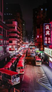 Stunning Nighttime Hong Kong Street with Red Minibuses Wallpaper