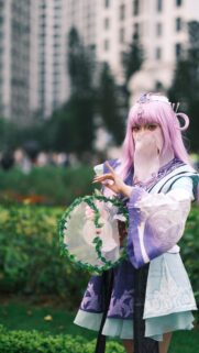 Ethereal Anime Cosplay Girl with Pink Hair and Floral Prop Wallpaper