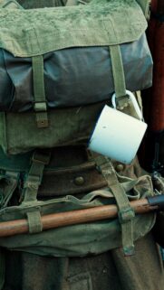 Vintage Military Gear and Enamel Cup Mobile Background Wallpaper