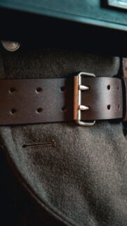 Close-up Dark Leather Double Prong Belt Mobile Wallpaper