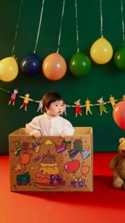 Cute Baby in Birthday Cardboard Box Festive Celebration Wallpaper