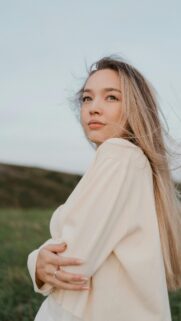 Dreamy Young Woman in Natural Outdoor Landscape Mobile Wallpaper