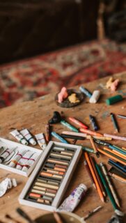 Artistic Desk Workspace with Oil Pastels and Paints Aesthetic Wallpaper