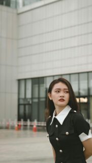 Elegant Young Woman in Black Uniform Style Fashion Wallpaper