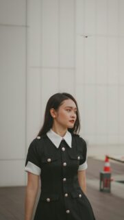 Elegant Young Woman in Black and White Uniform Portrait Wallpaper