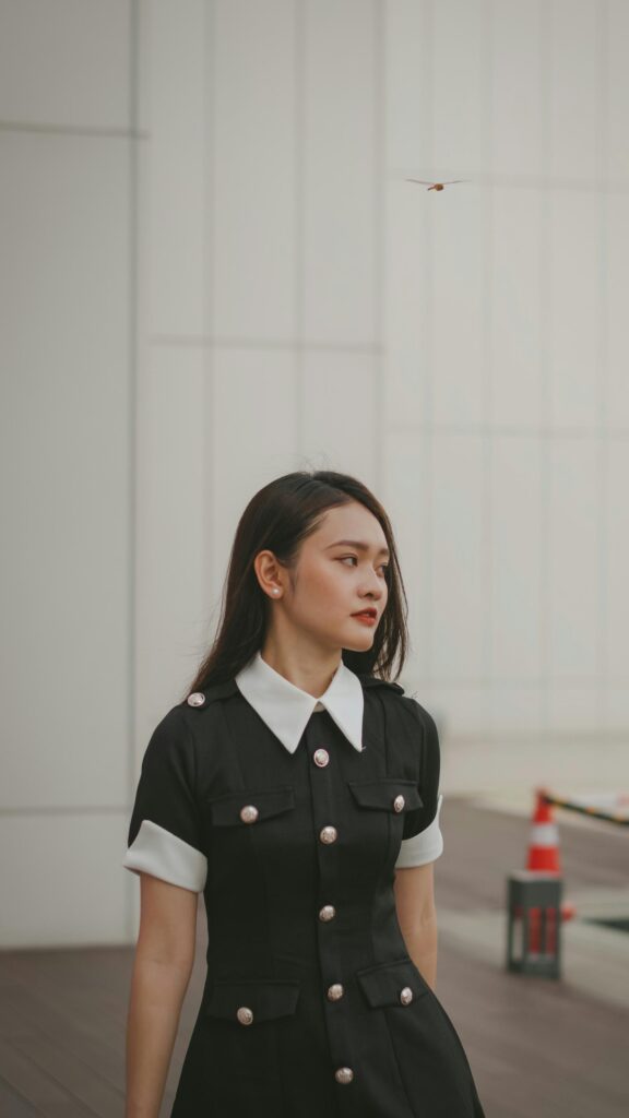 Elegant Young Woman in Black and White Uniform Portrait Wallpaper