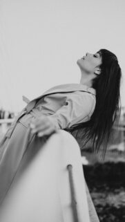 Elegant Woman in Trench Coat Aesthetic Black and White Mobile Wallpaper