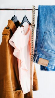 Chic Fashion Outfit Hanger with Trench Coat and Jeans Phone Wallpaper