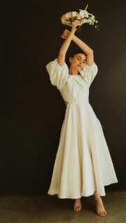 Elegant Bride in White Puff Sleeve Dress with Floral Bouquet Wallpaper