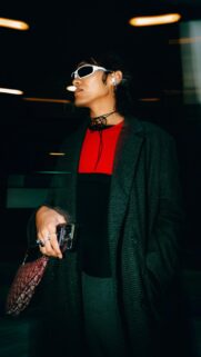 Stylish Fashionable Person in Dark Coat and Red Top Mobile Wallpaper