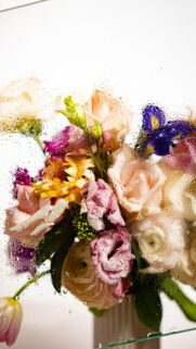 Stunning Bouquet of Pastel Flowers Behind Rainy Glass Mobile Wallpaper
