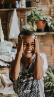 Joyful Young Boy Expressing Happiness High-Quality Mobile Wallpaper