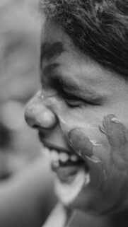 Joyful Person Laughing with Face Paint Mobile Wallpaper
