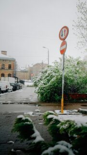 Snowy Street with Traffic Signs Mobile Phone Wallpaper
