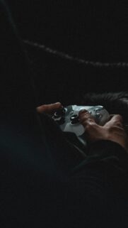 Immersive Gaming Session Close-up Hands with Controller Phone Wallpaper