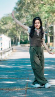 Cute Smiling Asian Girl in Stylish Cargo Pants Portrait Wallpaper