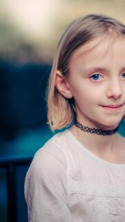 Stunning Close-Up Portrait of Young Girl with Blue Eyes Wallpaper