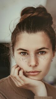 Stunning Portrait of a Young Woman with Freckles Mobile Wallpaper