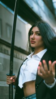Edgy Woman Holding Katana Sword Aesthetic Phone Wallpaper