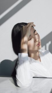 Serene Woman Resting in Sunlight Aesthetic Phone Wallpaper