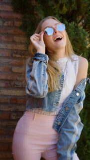 Stylish Blonde Girl in Denim Jacket and Pink Skirt Mobile Wallpaper