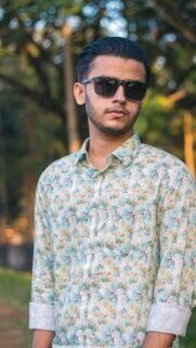 Portrait of a Stylish Young Man in a Patterned Shirt Mobile Wallpaper