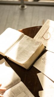 Open Bible on Dark Wooden Table Aesthetic 4K Wallpaper