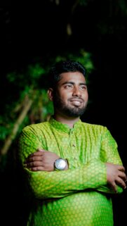 Confident Young Man in Traditional Green Panjabi Portrait Wallpaper