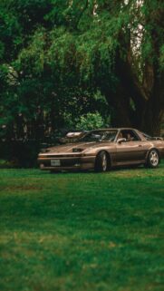 Stunning Gold Toyota Supra A70 Parked on Lush Green Grass Wallpaper