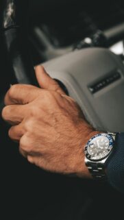 Luxury Rolex GMT-Master II Watch on Steering Wheel Phone Wallpaper