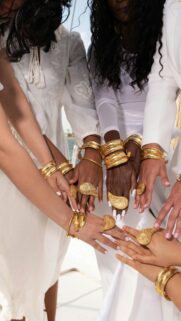 Elegant Hands with Gold Jewelry and White Outfits Mobile Wallpaper