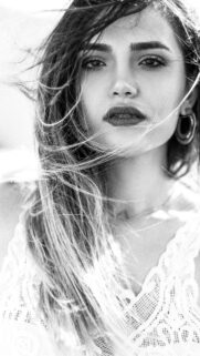 Stunning Portrait of a Woman with Windblown Hair Aesthetic Wallpaper