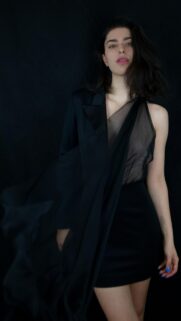 Stunning Fashion Model in Chic Black Attire Mobile Wallpaper