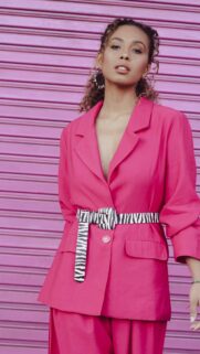 Stylish Woman in Hot Pink Suit with Zebra Print Belt Mobile Wallpaper