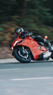 Red Ducati Panigale V4 Sportbike Racing on Road High Quality Wallpaper