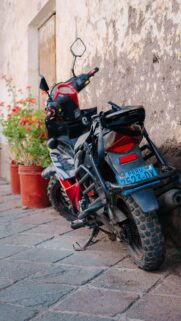 Red and Black Peruvian Motorcycle on Cobblestone Street Wallpaper