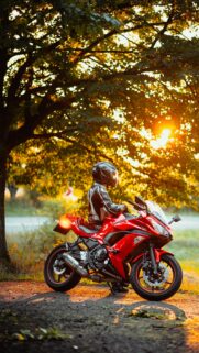 Stunning Red Kawasaki Ninja Sportbike Under Golden Hour Sun Wallpaper
