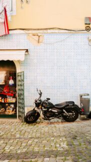 Black Cruiser Motorcycle Parked Against Tiled Wall Wallpaper