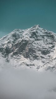 Snow-Covered Mountain Peak Above Clouds Mobile Wallpaper