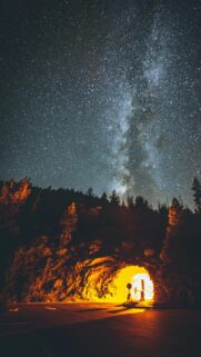 Starry Milky Way Galaxy over Glowing Mountain Tunnel Wallpaper