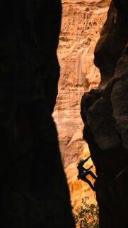 Climbing Silhouette in Narrow Desert Canyon High Quality Wallpaper