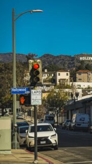 Iconic Hollywood Sign Over Busy Street Traffic Phone Wallpaper