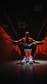 Cool Hip Hop Artist in Red Room Cinematic Phone Wallpaper