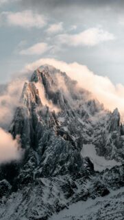 Majestic Snowy Mountain Peak Above the Clouds Phone Wallpaper
